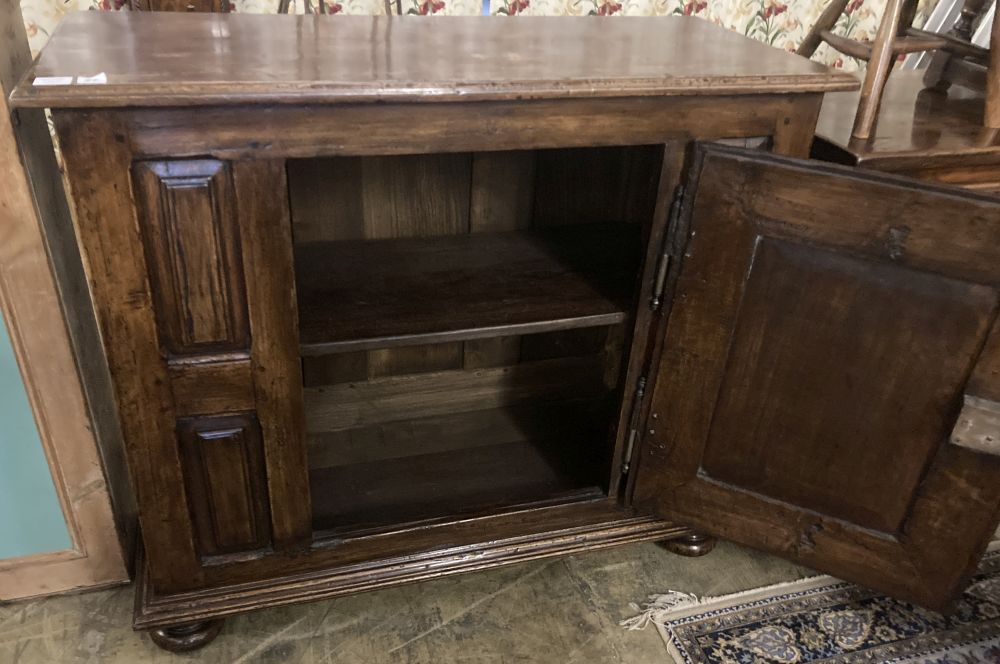 A mid 18th century French provincial walnut cupboard, enclosed by a single door, width 117cm, depth 52cm, height 100cm